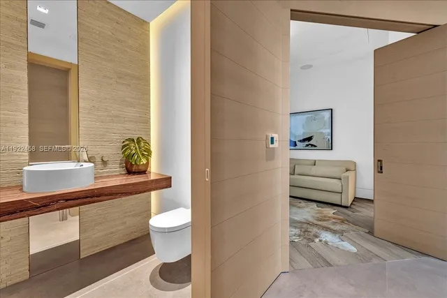 a bathroom with a toilet a sink and mirror