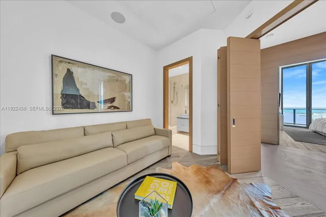 a living room with furniture and a wall painting