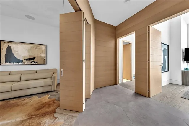 a large bed sitting in a bedroom next to a window