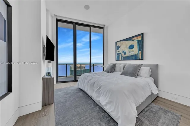 a bedroom with a bed and a view of bathroom