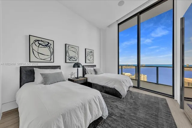 a en suite bathroom with a granite countertop tub and a large window