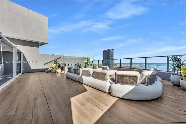a view of a hallway with wooden floor and dining room