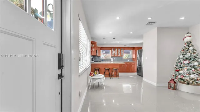 a dinning table and kitchen with a large window