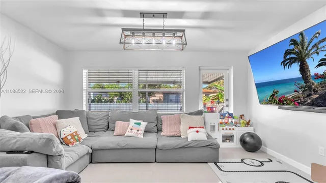 a living room with furniture and a large window