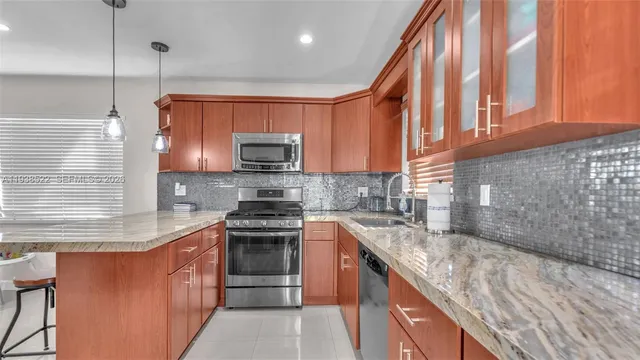 a kitchen with refrigerator and window