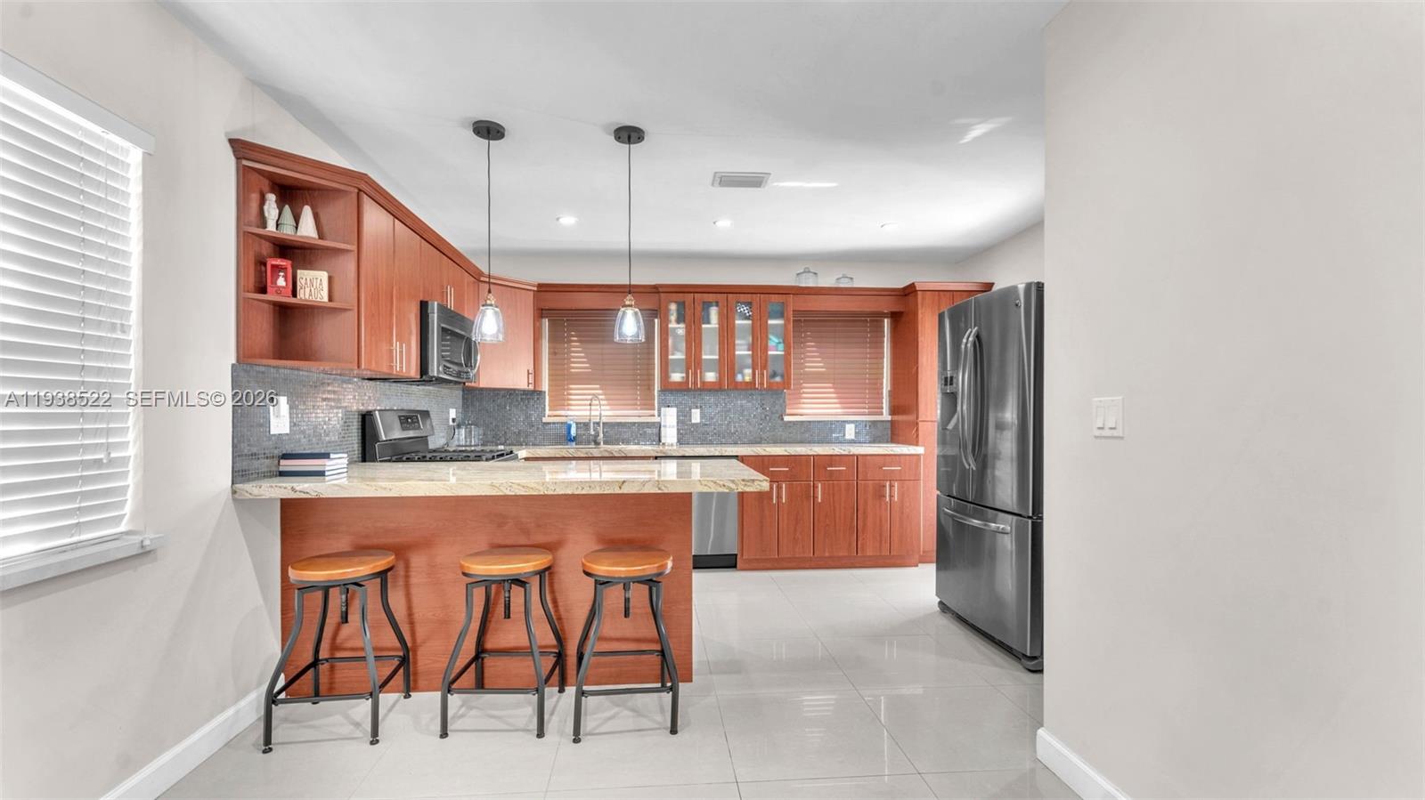 8261 Southwest 27th Street Miami, FL 33155 - Photo 23 of 27 a large kitchen with a large counter top space a sink stainless steel appliances and cabinets