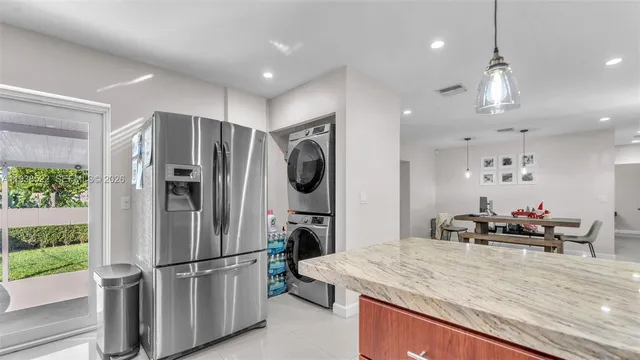 a kitchen with kitchen island white cabinets and stainless steel appliances