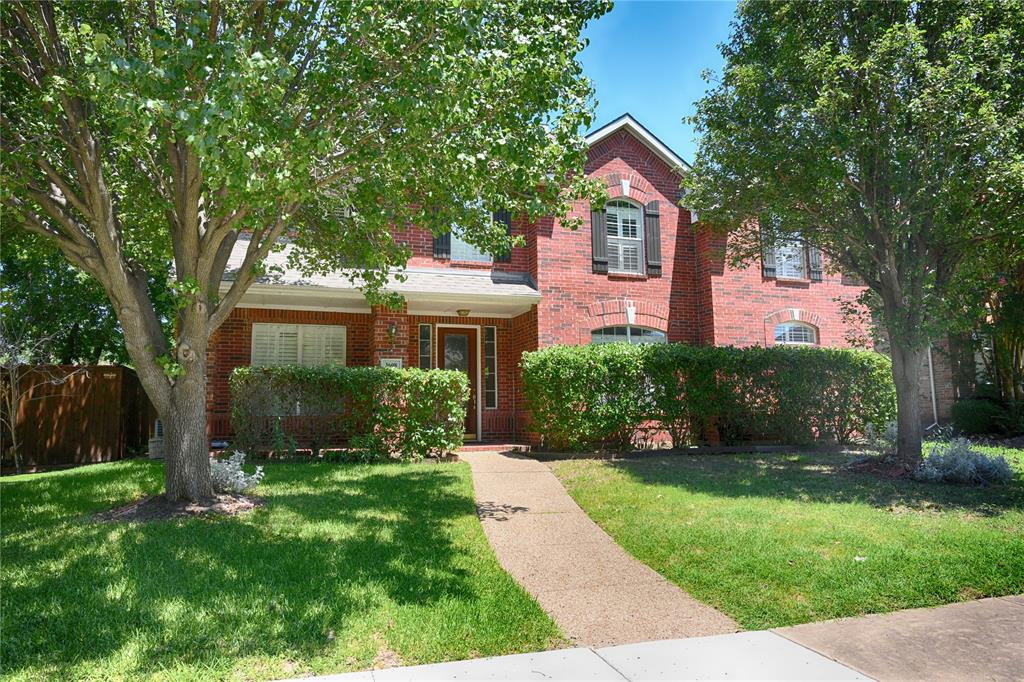 Traditional home featuring brick siding