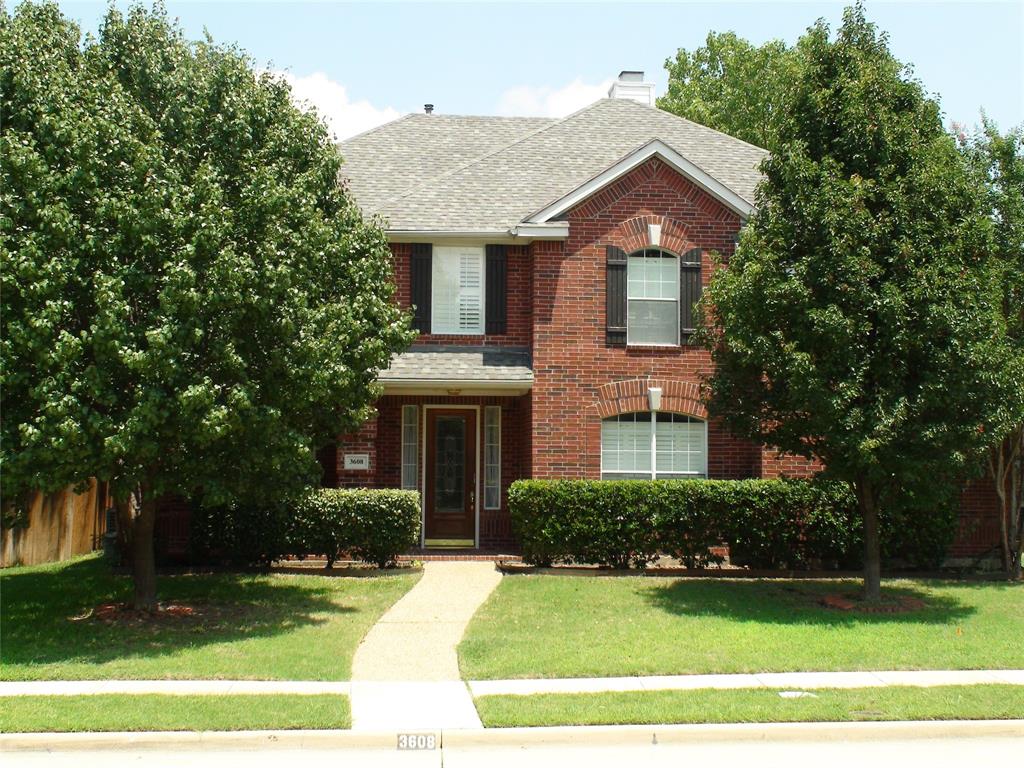 3608 Bent Ridge Drive Plano, TX 75074 - Photo 5 of 16 Traditional home featuring a shingled roof, brick siding, and a chimney