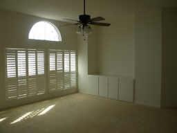 3608 Bent Ridge Drive Plano, TX 75074 - Photo 7 of 16 Spare room featuring a ceiling fan, wainscoting, and a decorative wall