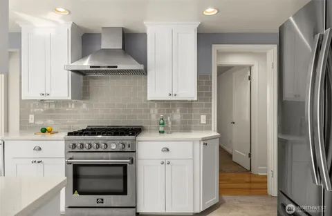a kitchen with stainless steel appliances a stove a refrigerator and a sink
