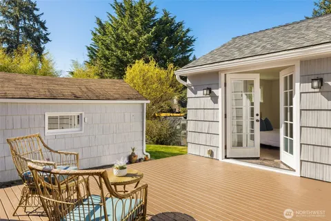 a view of house with backyard and trees