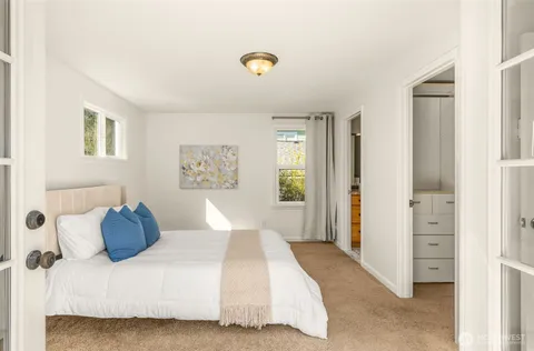 a bedroom with a bed and a window