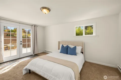a bedroom with a bed and a painting on the wall