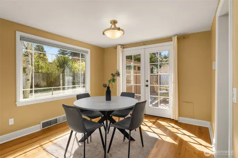 a view of a dining room with furniture and a window