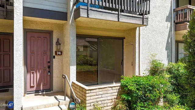 a view of front door and potted plants