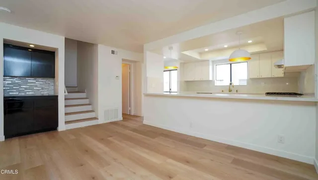 a view of an empty room with a fireplace and a large window