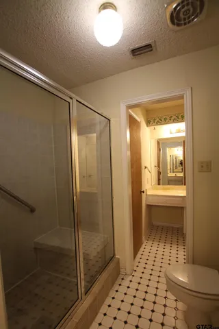 a bathroom with a glass shower door