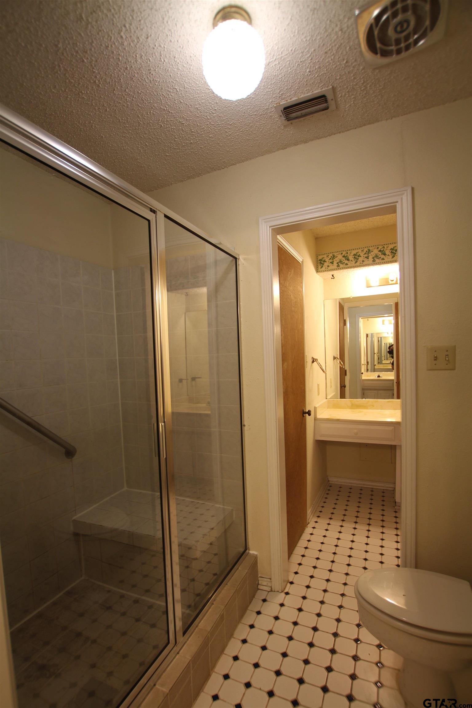 4210 Heather Lane Tyler, TX 75703 - Photo 13 of 27 a bathroom with a glass shower door