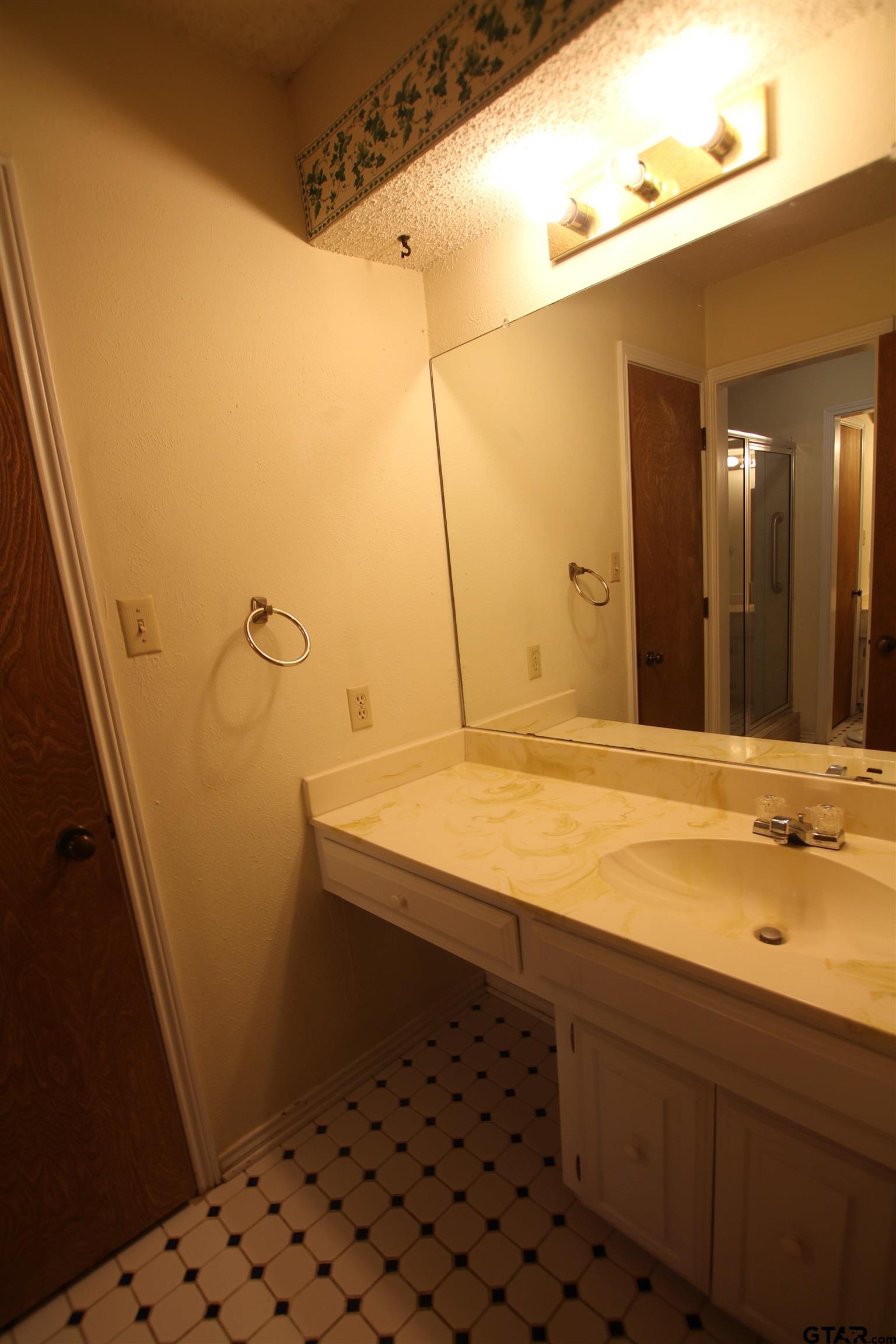 4210 Heather Lane Tyler, TX 75703 - Photo 15 of 27 a bathroom with a sink and a mirror