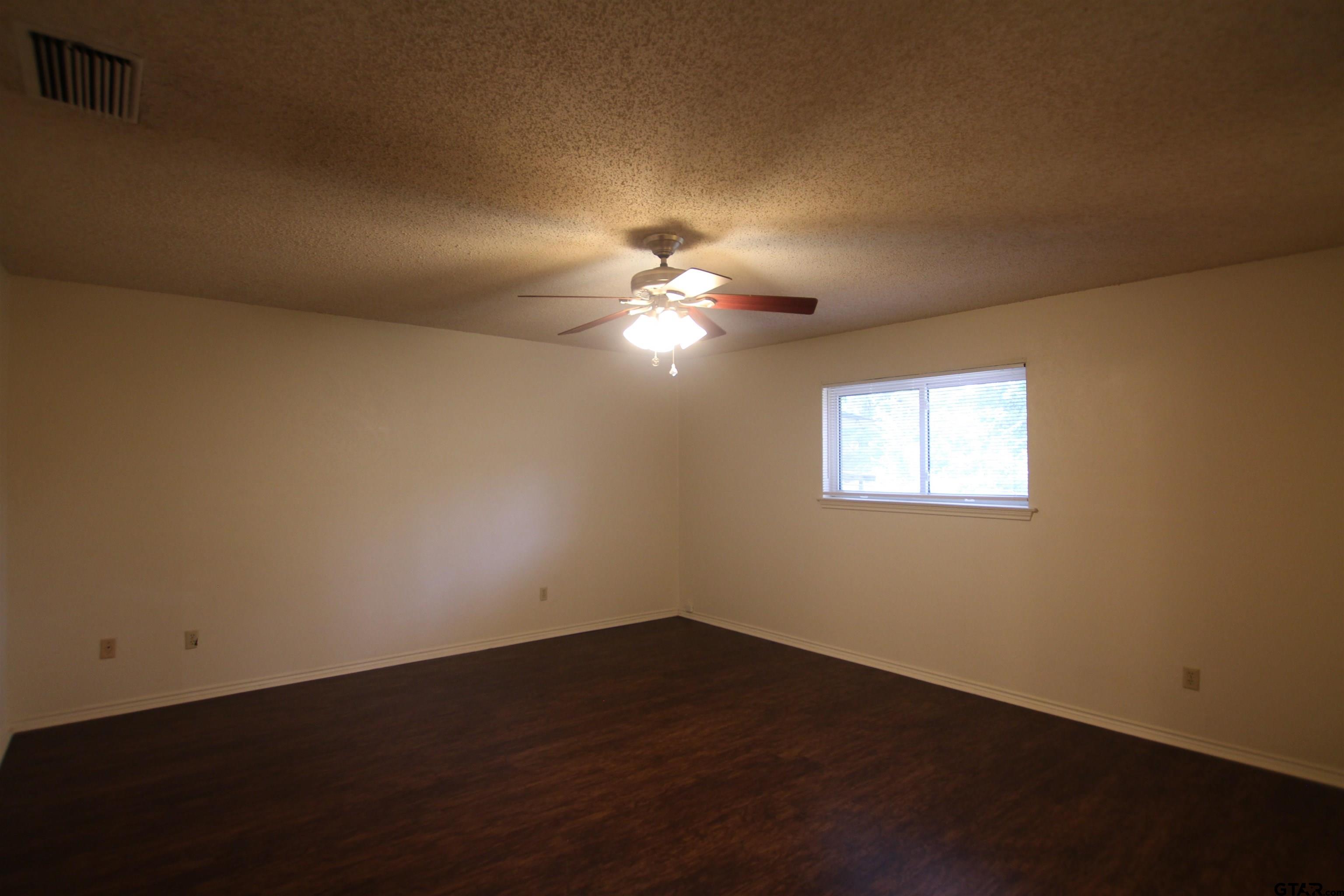 4210 Heather Lane Tyler, TX 75703 - Photo 19 of 27 a view of wooden floor and windows in a room