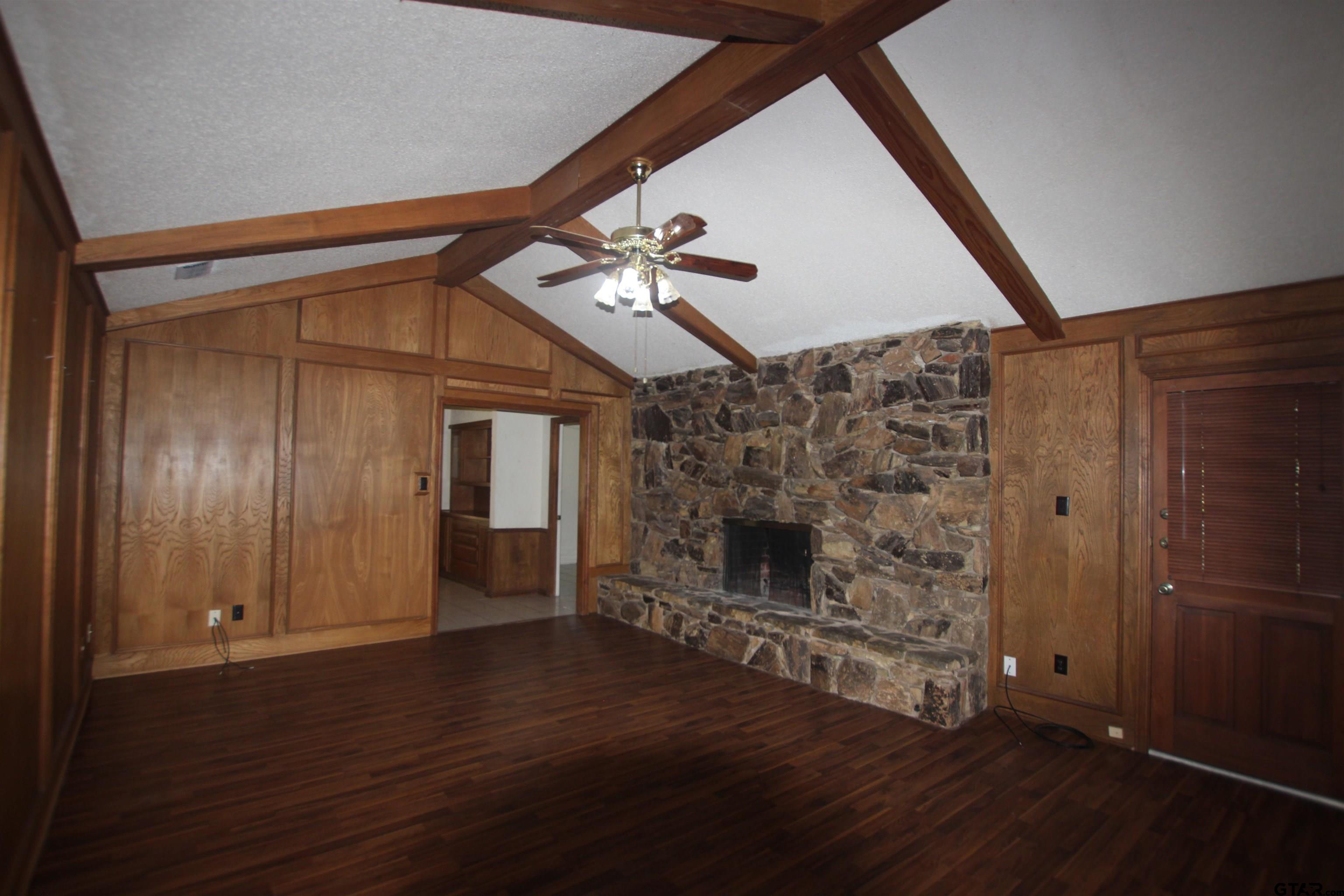 4210 Heather Lane Tyler, TX 75703 - Photo 2 of 27 wooden floor in an empty room with a fireplace
