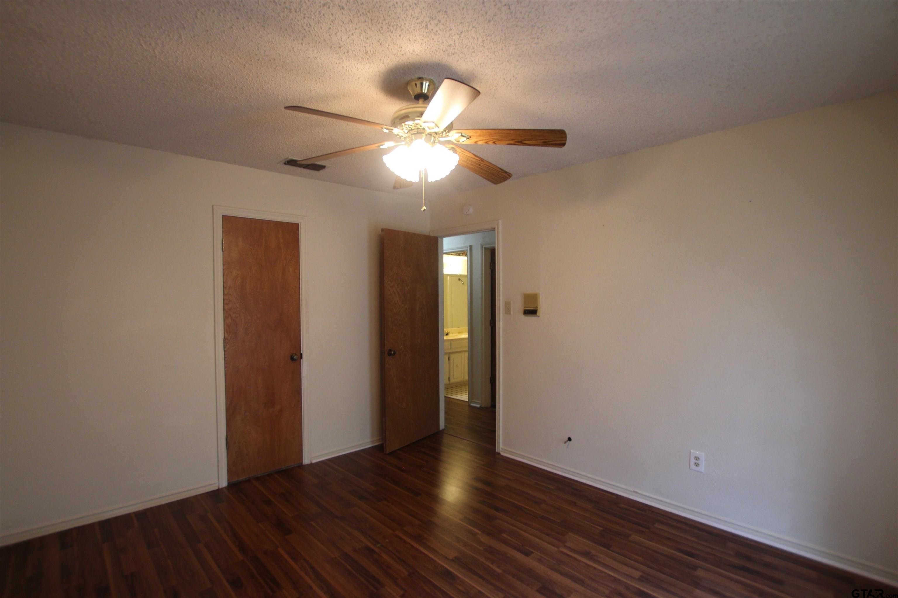 4210 Heather Lane Tyler, TX 75703 - Photo 21 of 27 a view of an empty room with wooden floor