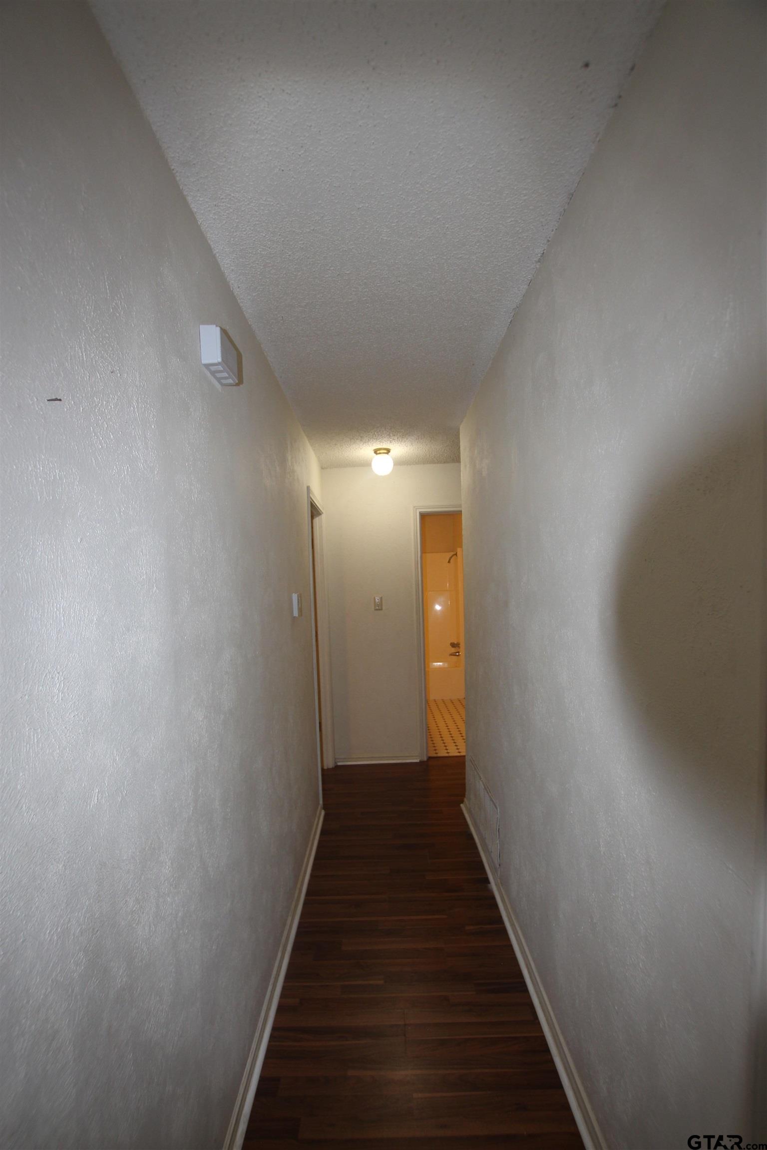 4210 Heather Lane Tyler, TX 75703 - Photo 22 of 27 a view of a hallway with wooden floor