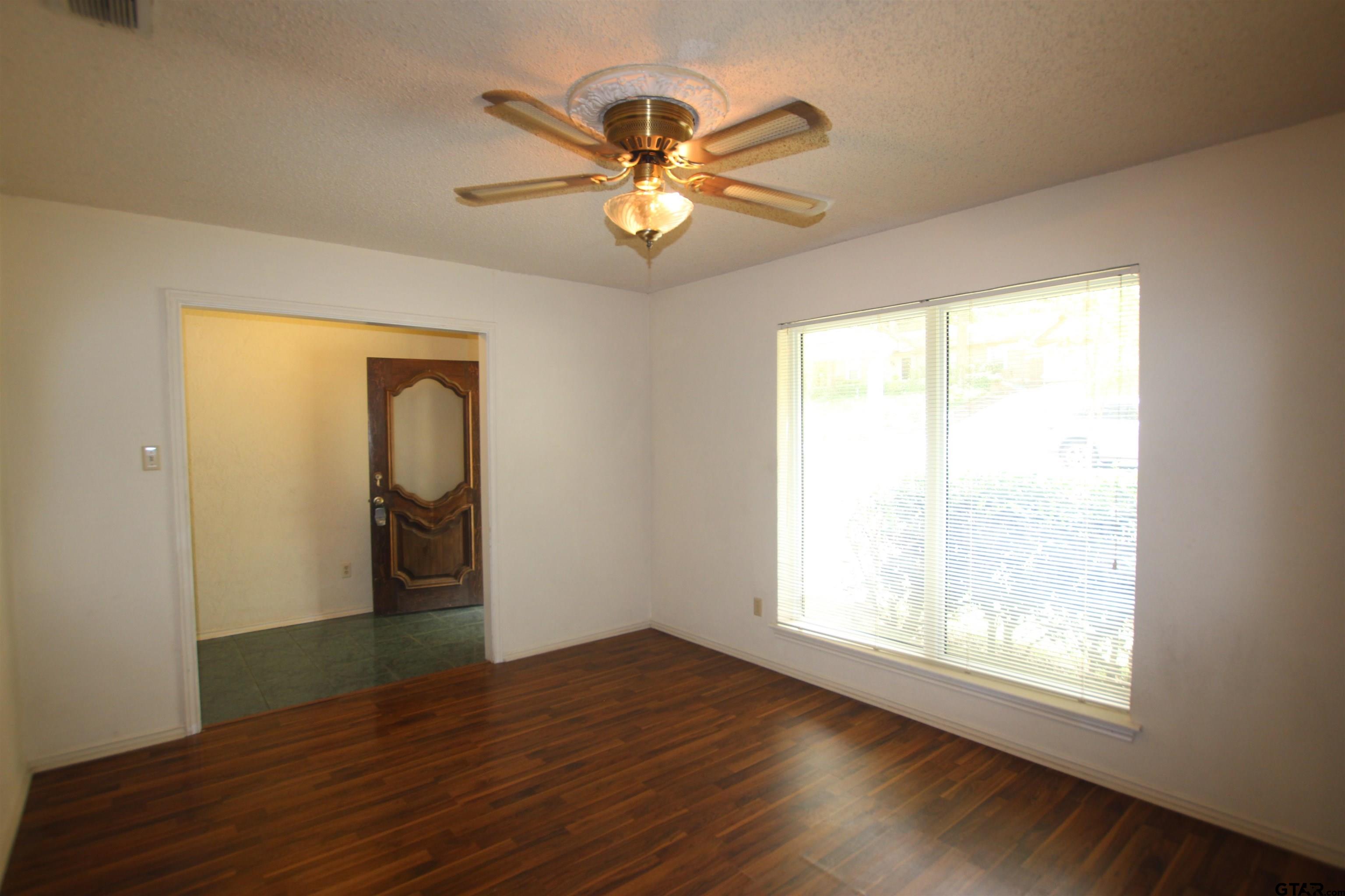 4210 Heather Lane Tyler, TX 75703 - Photo 5 of 27 a view of a livingroom with a window and wooden floor