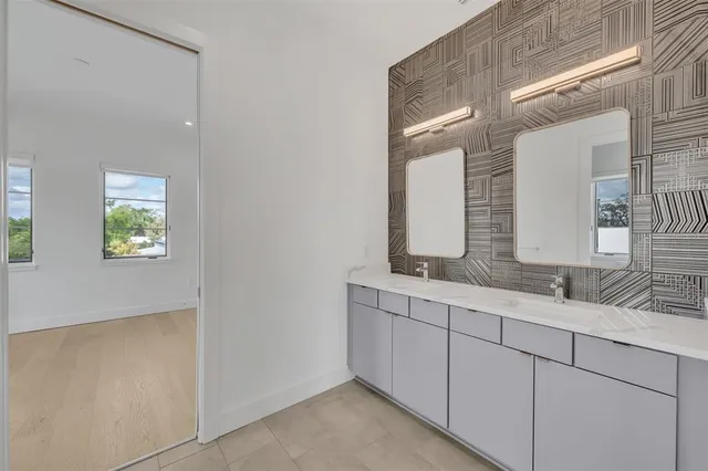 a bathroom with 2 sink and a mirror