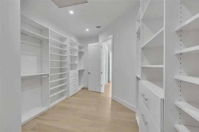 a view of walk in closet with empty racks