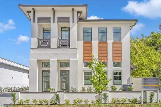 front view of a brick house with a yard