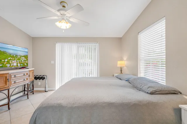 a spacious bedroom with a bed and a chandelier