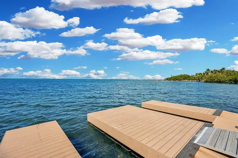 a view of a house with a yard and a wooden fence