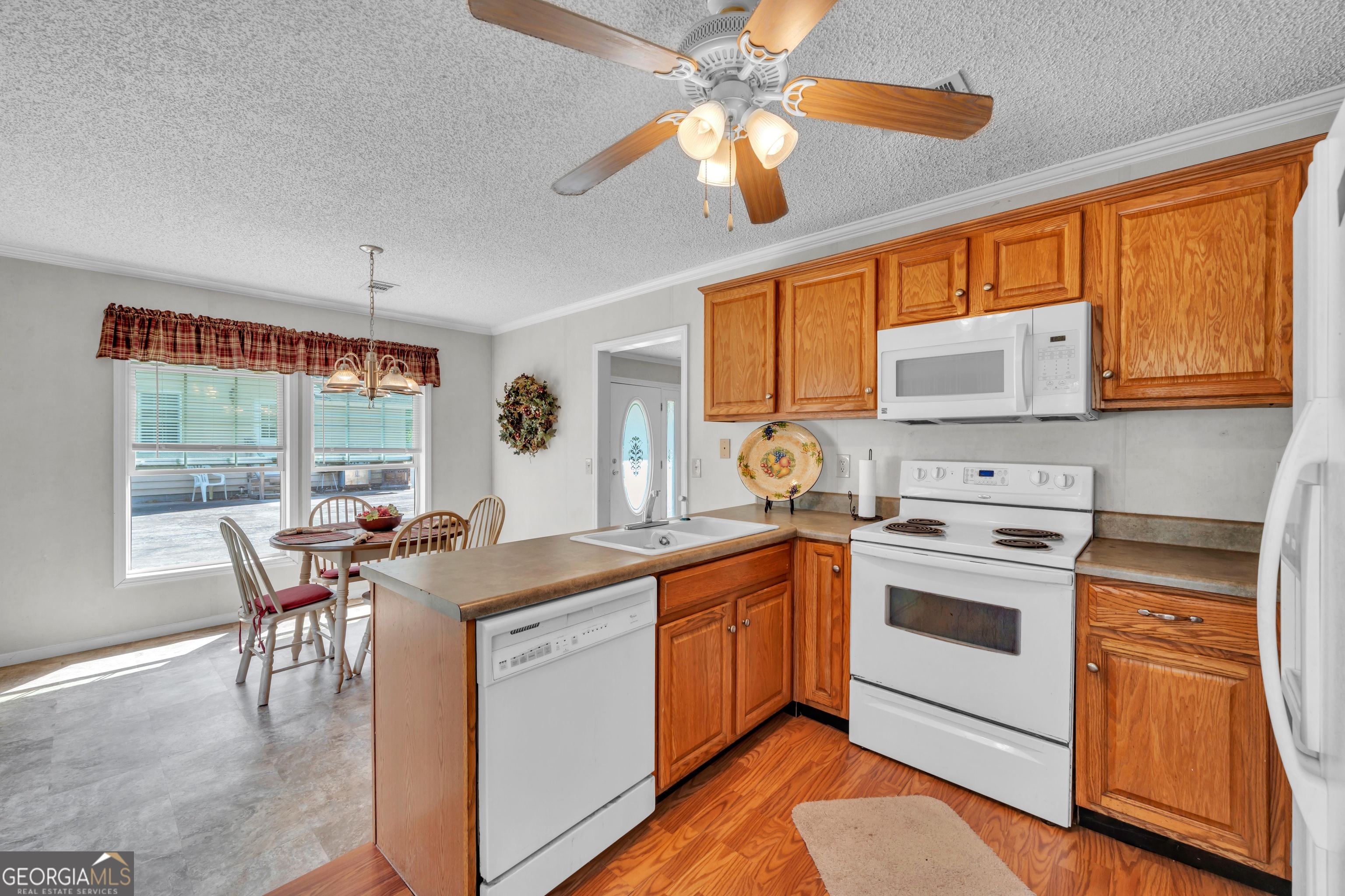 87 Georgia Avenue Adrian, GA 31002 - Photo 63 of 74 a kitchen with stainless steel appliances granite countertop a stove and a refrigerator