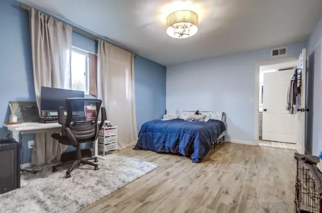 a spacious bedroom with a bed and a table in it