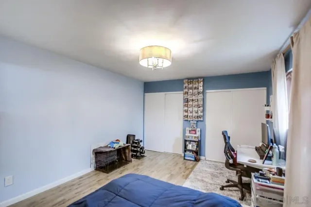 a view of a workspace with furniture and wooden floor