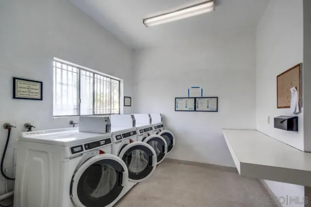 a utility room with sink dryer and washer