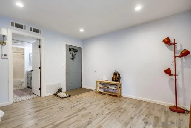 a view of a livingroom with wooden floor and closet