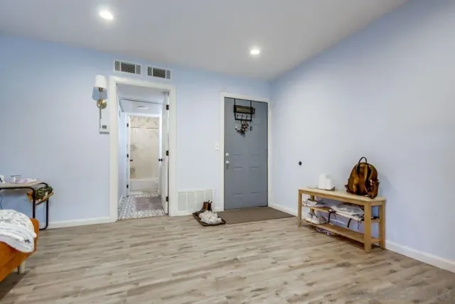 a view of room with wooden floor and furniture