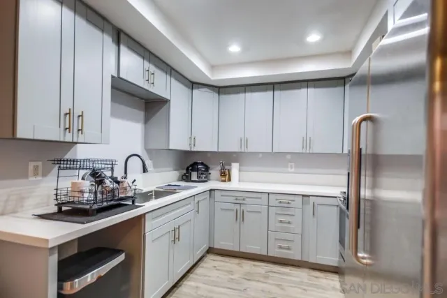 a kitchen with a sink stainless steel appliances and cabinets