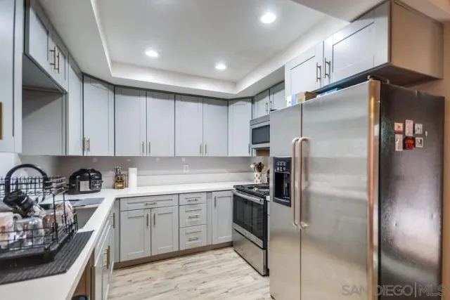 a kitchen with a sink stainless steel appliances and cabinets