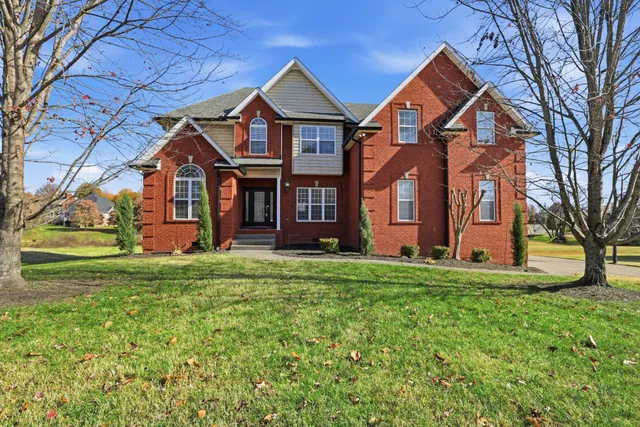 a front view of a house with a yard