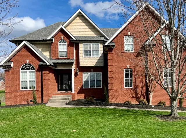 a front view of a house with a yard