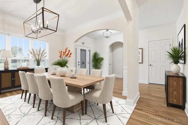 a view of a dining room with furniture and a chandelier