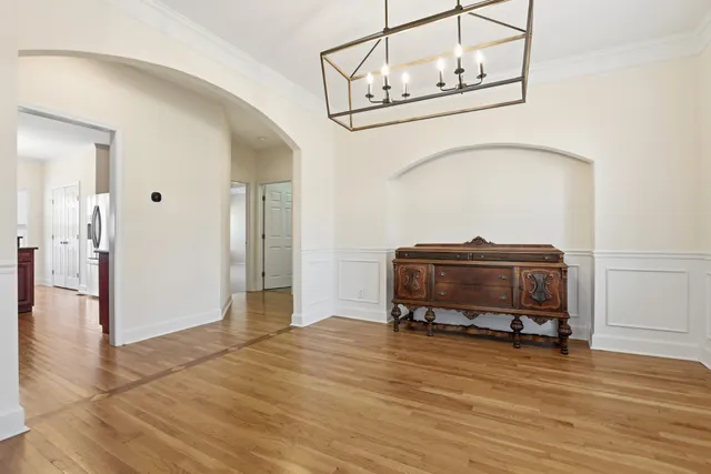 a room with a wooden floor and furniture