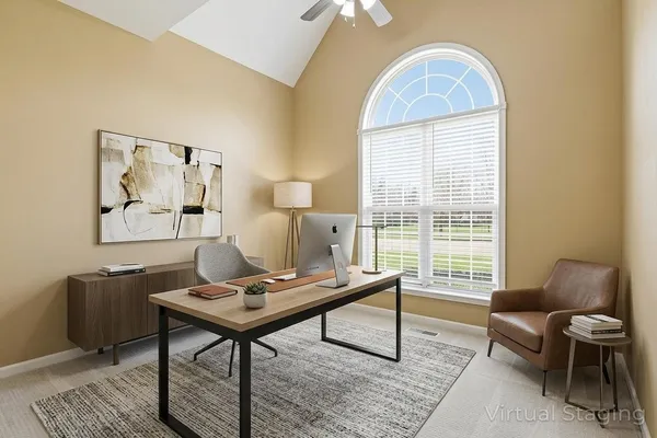 a view of a room with wooden floor and a large window