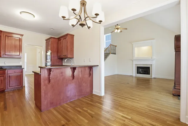a view of kitchen and hallway with wooden floor