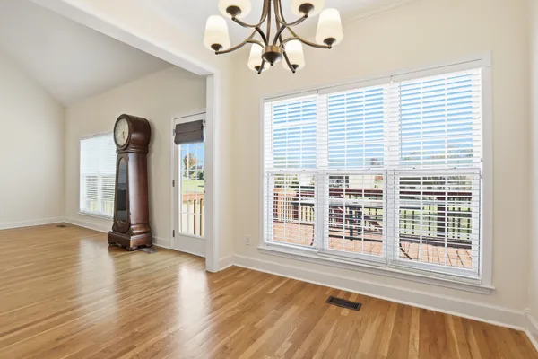 a kitchen with stainless steel appliances granite countertop a stove a sink dishwasher and wooden cabinets with wooden floor