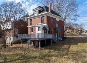 9600 Frankstown Road Pittsburgh, PA 15235 - Photo 24 of 28 a front view of a house with a yard and garage